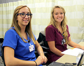 students in scrubs at computer