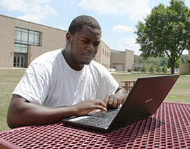 Male outside on laptop
