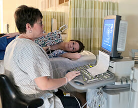 Cardiac sonographer with patient
