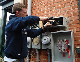 male student working on electrical meter
