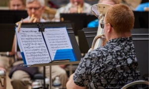 A member of the capital city brass band playing at their summer concert series.