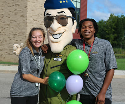Two students with mascot Jax