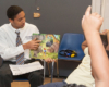 male men of merit student reading to kids