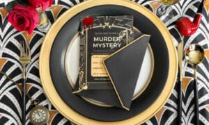 view of a plate with a murder mystery invitation on top