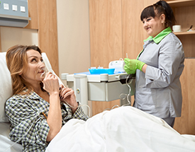 female medical worker talking to female patient