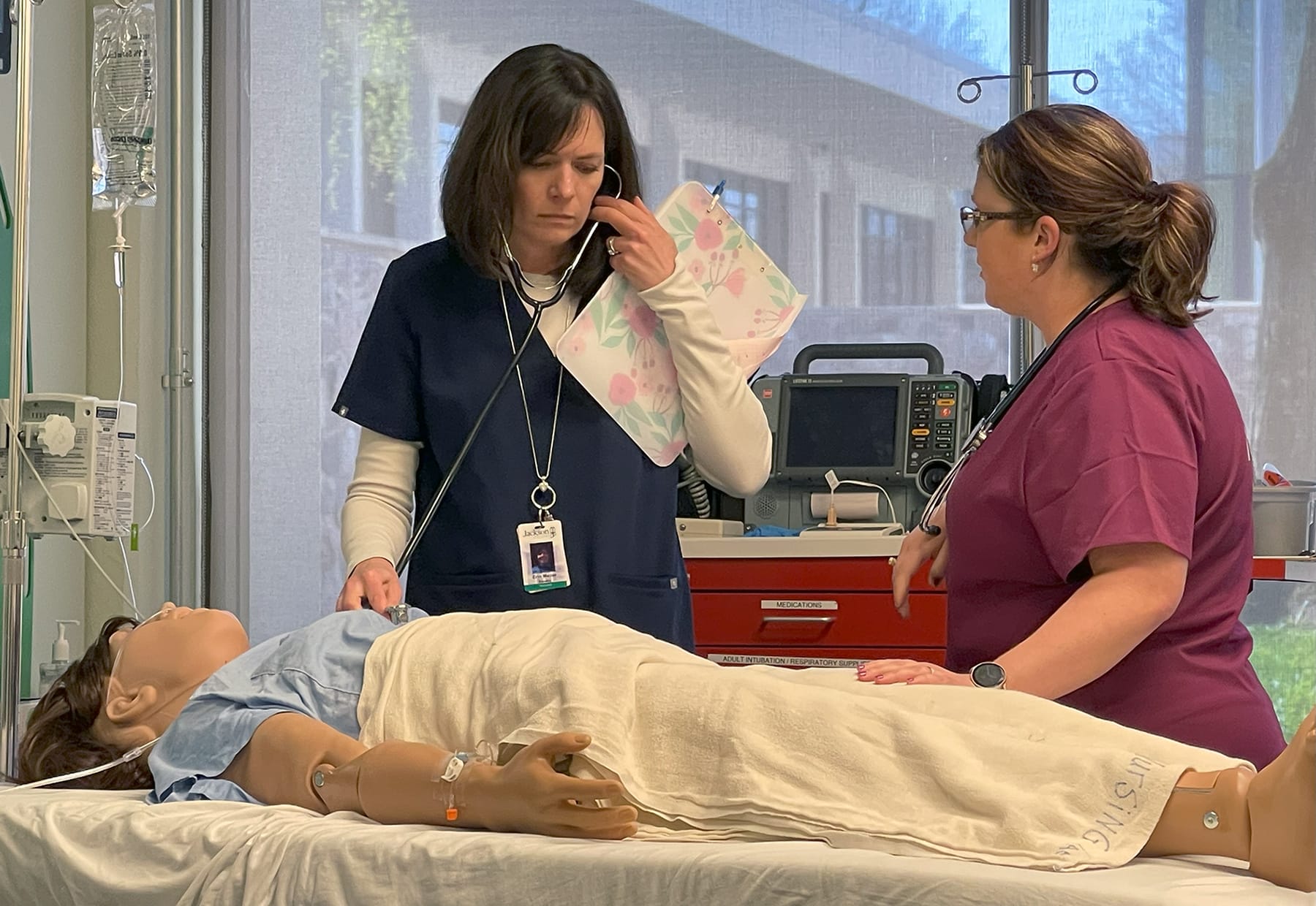 Nursing professor Erin Mazur with manikin, student in simulation exercise